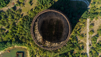 Aerial top view of unfinished cooling towers for the nuclear reactors of third stage of Chernobyl nuclear power plant. Drone above shot Exclusion Zone in summer on a sunny day. Radiation
