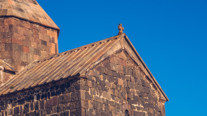 Closeup view of an old Sevanavank church in Sevan. Blue sky and bright autum colors on the sunny day. Ancient temple stock photography.