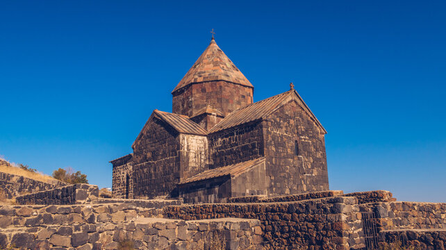 Scenic view of an old Sevanavank church in Sevan. Blue sky and bright autum colors on the sunny day. Ancient temple stock photography.