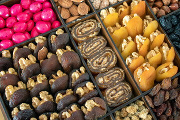 various nuts, candies and Turkish delight, stacked in the box.