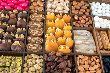various nuts, candies and Turkish delight, stacked in the box.