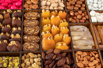 various nuts, candies and Turkish delight, stacked in the box.