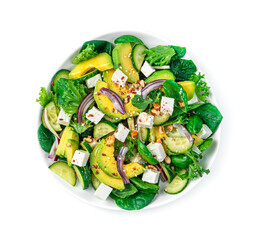 Vegetable salad with avocado, cucumber, feta and herbs seasoned with nuts and sesame seeds and flax is isolated on a white background.