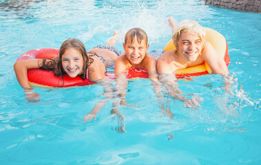 Children Having Fun In Outdoor Swimming Pool