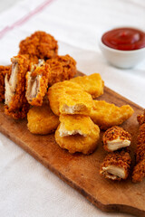 Tasty Fastfood: Chicken Nuggets, Wings and Tenders with Ketchup, low angle view. Close-up.