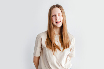 Obraz premium Portrait of young beautiful cute cheerful girl smiling over white background