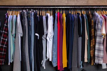 Assortment of summer and autumn clothing in modern garment store interior