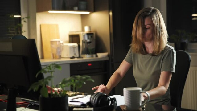 Woman working remotely online at home office, using computer, Freelancer procrastinate at home workplace, spinning on chair