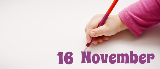 A child's hand writes 16 november in a lilac pencil. Banner with copy space