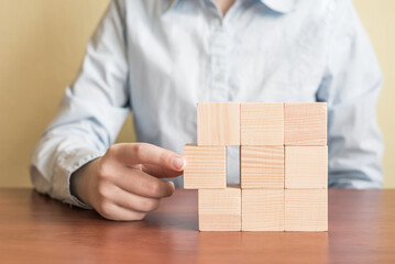 Hand of a man picked wood blocks