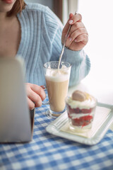 a latte on a girl's table at a coffee shop