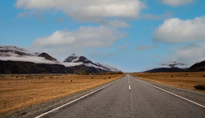 Banner of traveling  explore on the road with mountain range near Aoraki Mount Cook and the road leading to Mount Cook Village in New zealand.
