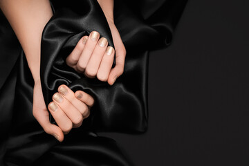 Female hands with glitter gold nail design. Glitter golden nail polish manicure. Female model hands...