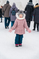 Fototapeta na wymiar child happy at ice sculpture festival on winter day