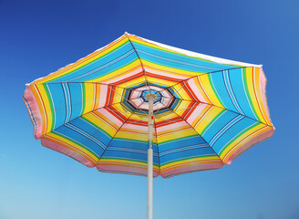 Colorful beach parasol at blue sky