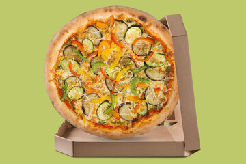 Italian vegetarian pizza with zucchini and eggplant, in an open box, on a green background