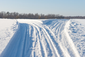Fototapeta na wymiar Snowmobile road close up. Winter landscape