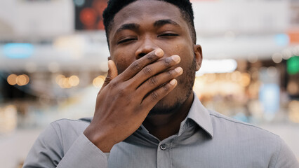 Male portrait close-up man overworked young african american man tired worker looking at camera...