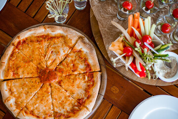 Decorated catering banquet table with different food appetizers assortment on a party