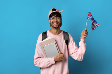 Happy arabic guy student showing flag of UK