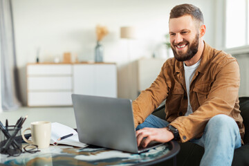 Male Freelancer Using Laptop Computer Working Online Sitting At Home