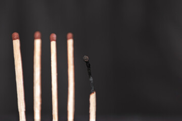 Five matches on a black background. Emotional or physical burnout of an employee at work. Loss of a member of the team. Loss of an ally.