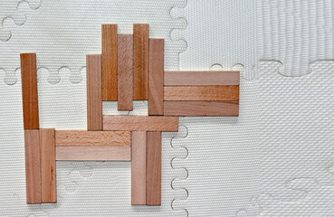 a wooden dog made from a constructor for children on a light background
