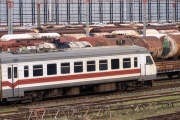 Fototapeta premium Old train on the background of cargo tanks at the railway station