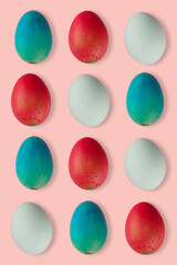group of colored easter eggs on pink background