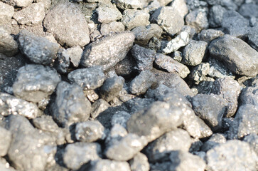 Large stones of black industrial coal, selective focus. Minerals