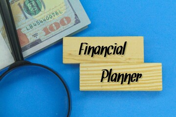 magnifying glass, banknotes and wooden boards with the words Financial Planner