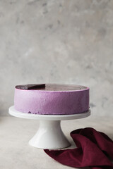 Traditional German cheesecake with lavender and blueberry. Slice of mousse cake, cheesecake with fresh berry on a white  background