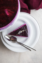 Traditional German cheesecake with lavender and blueberry. Slice of mousse cake, cheesecake with fresh berry on a white  background