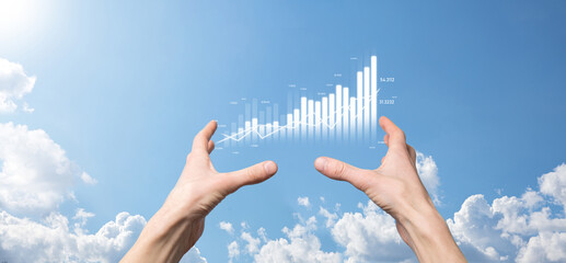 Business man holding tablet and showing holographic graphs and stock market statistics gain profits. Concept of growth planning and business strategy. Display of good economy form digital screen.