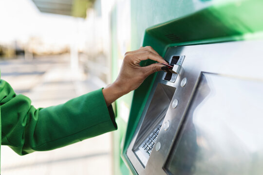 Businesswoman's hand inserting smart card in ticket machine
