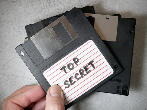 Top secret information on retro vintage floppy disk magnetic computer, thief information concept