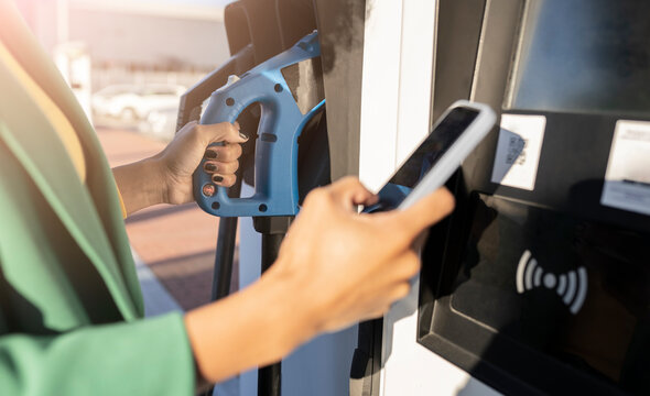 Commuter scanning QR code at gas station
