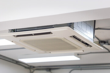 Modern ceiling mounted cassette type air conditioning system in coffee shop