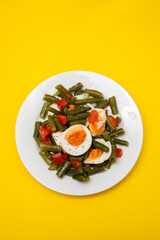 healthy salad green beans, pepper and boiled eggs on plate