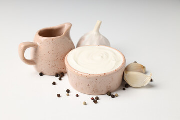 Concept of cooking garlic sauce on white background