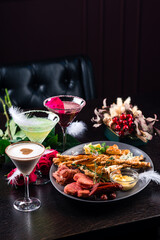 Three different beautiful cocktails on a flower background. cocktail or bar menu concept.