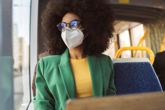 Businesswoman with protective face mask in tram