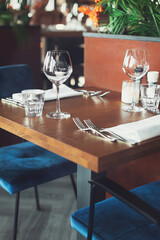 Empty glasses and cutlery on the table. Breakfast, dinner or lunch preparation in the restaurant or hotel.