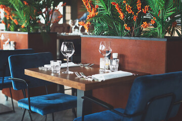 Empty glasses and cutlery on the table. Breakfast, dinner or lunch preparation in the restaurant or hotel.