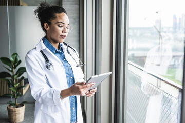 Young doctor using tablet PC in hospital