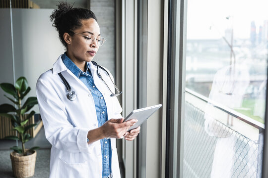 Young doctor using tablet PC in hospital
