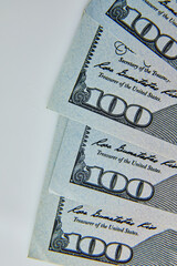 Flat lay Closeup on the bills for a US hundred dollar banknote, fragment of dollar bill, money background, copy space.
