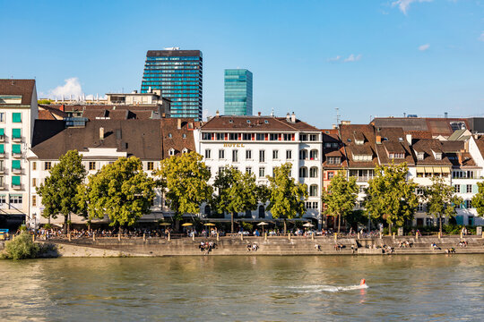 Switzerland, Basel-Stadt, Basel, Riverside promenade in summer with row of old town apartments in background