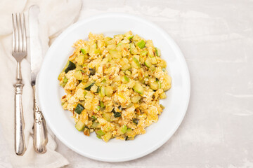 scrambled egg with zucchini on white small plate