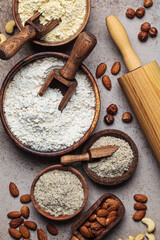 Different types of nut flour - almond, hazelnut and cashew, dark background. Keto diet and gluten-free concept.
